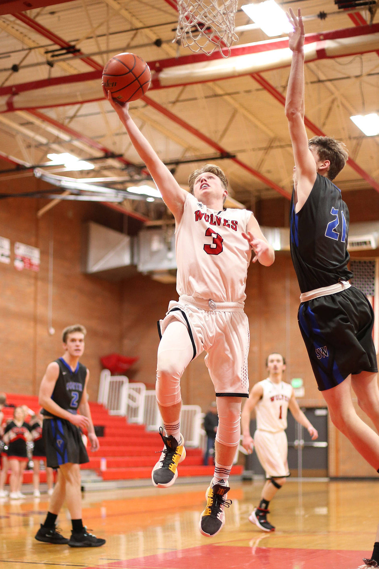Falcons fly by scrappy Wolves / Boys basketball