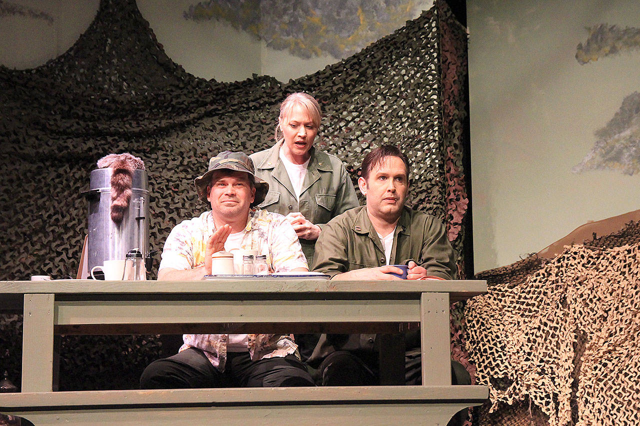 Photos by Laura Guido/Whidbey News-Times                                Troy Haugen as Hawkeye Pierce, left, and Dustin Amundson as Duke Forrest have one of their many disagreements with Maj. Margaret Houlihan, played by Shantel Porter, during Whidbey Playhouse’s production of M*A*S*H 4077.