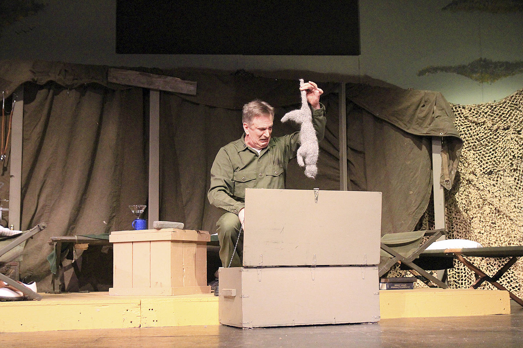 Photos by Laura Guido/Whidbey News-Times                                Ben Huneycutt, playing stick-in-the-mud Capt. Frank Burns pulls a dead cat from his trunk. No real cats were harmed in the production of this play.