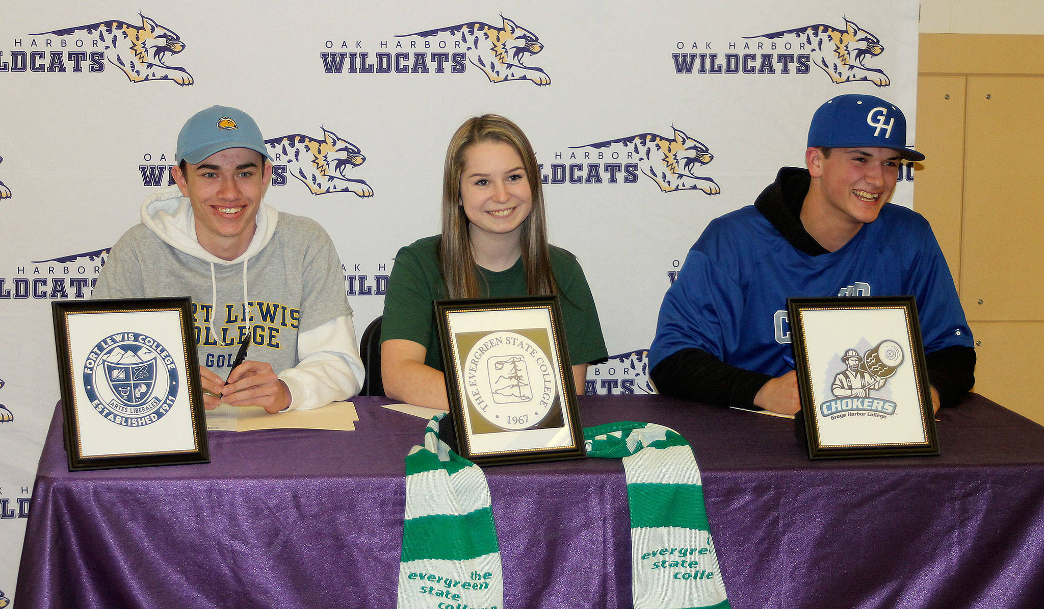 Oak Harbor seniors Nick Krantz, left, Peyton Rhyne and Aidan McCarthy all signed letters of intent Tuesday. (Photo by Jim Waller/Whidbey News-Times)