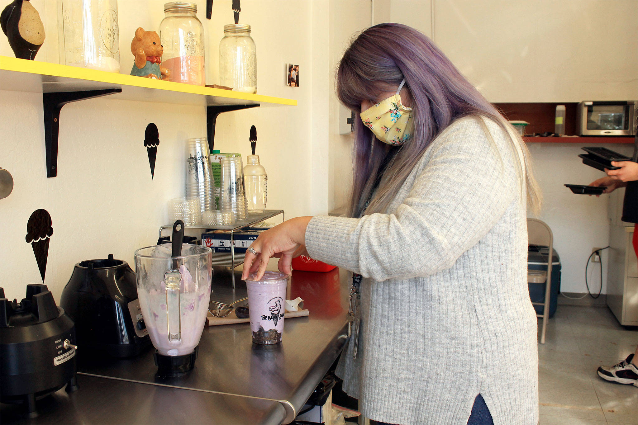 Photo by Kira Erickson/Whidbey News-Times                                Veronica Anguiano, who owns the Beary Scoop in Freeland with her husband, Mario Saenz, prepares a taro bubble tea, a blended Taiwanese sweet drink. The shop, which first opened in March, and reopened June 23, offers a combination of frozen yogurt and bubble tea.