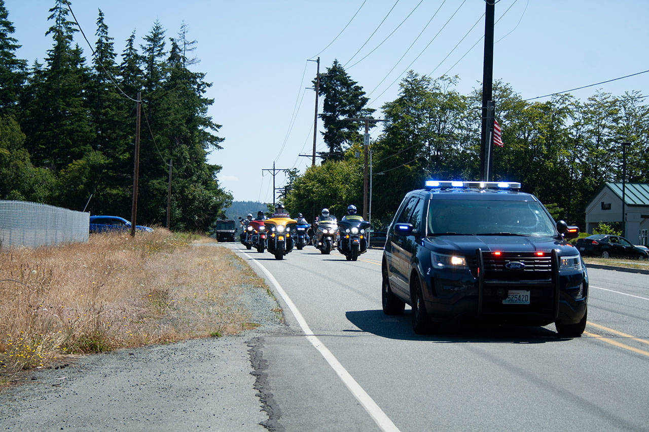 Oak Harbor Police provided an escort for Roy Derrick’s funeral procession to Sunnyside Cemetery in Coupeville. Photo by Brandon Taylor
