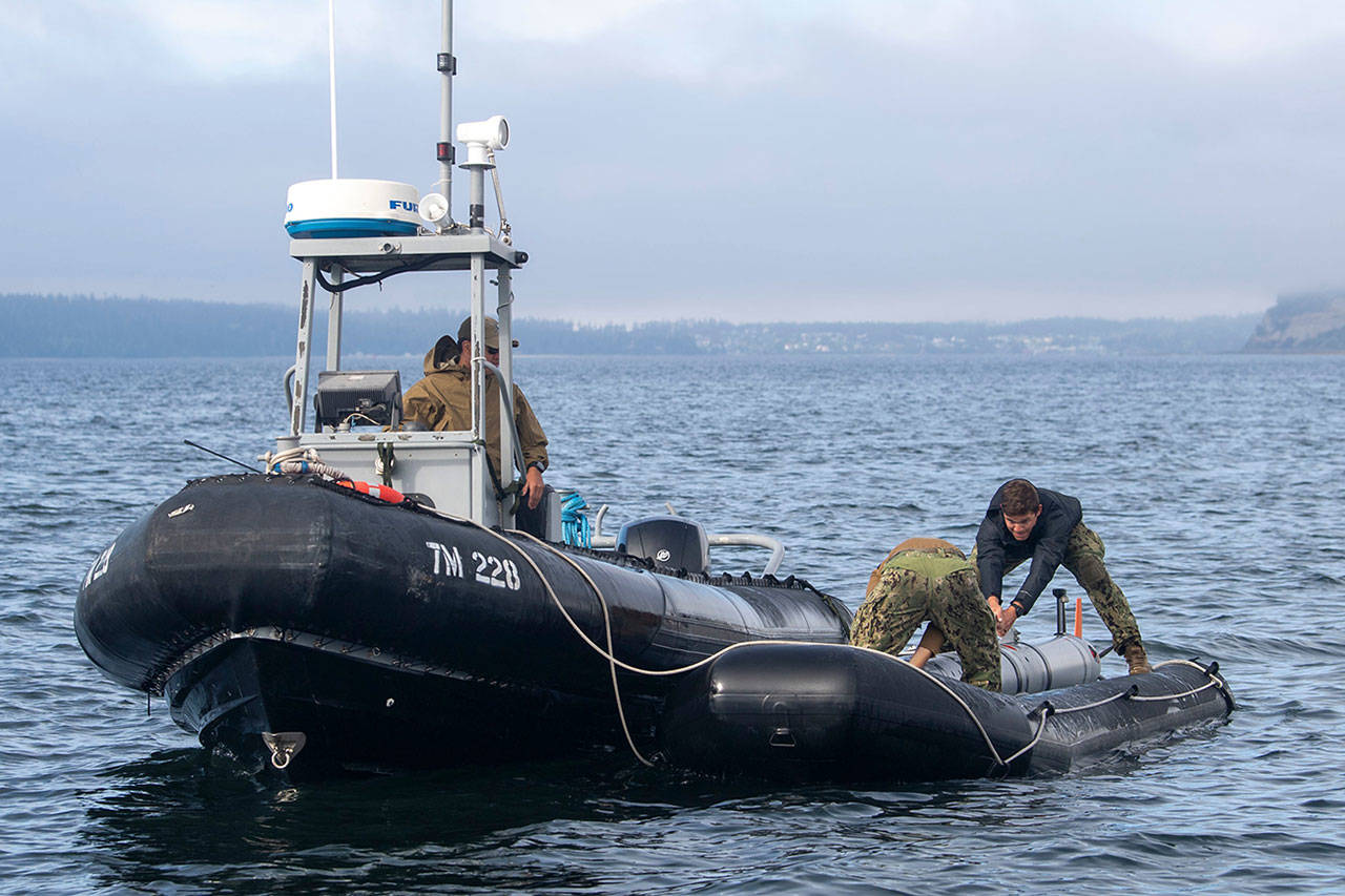Personnel attached to Explosive Ordnance Disposal Mobile Unit (EODMU) 1 prepare a Mark 18 Mod 2 Kingfish unmanned underwater vehicle (UUV) for launch and recovery in Crescent Harbor near Naval Air Station Whidbey Island, Wash., during a Certification Exercise (CERTEX), July 16. As part of the CERTEX, elements of EODMU-1 and EODMU-5 demonstrated their ability to maintain freedom of navigation and sea control of key waterways by clearing inert mines in Crescent Harbor and the Saratoga Passage. U.S. Navy EOD is the world’s premier combat force for eliminating explosive threats so the Fleet and nation can fight and win wherever, whenever and however it chooses. U.S. Navy photo by Mass Communication Specialist 2nd Class Marc Cuenca/Released