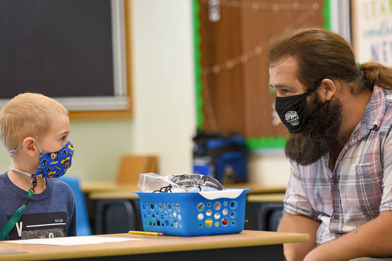 Paraeducator Brion Lanata speaks with student Keaka Mollitor. Photo by Conor Laffey / Oak Harbor Schools