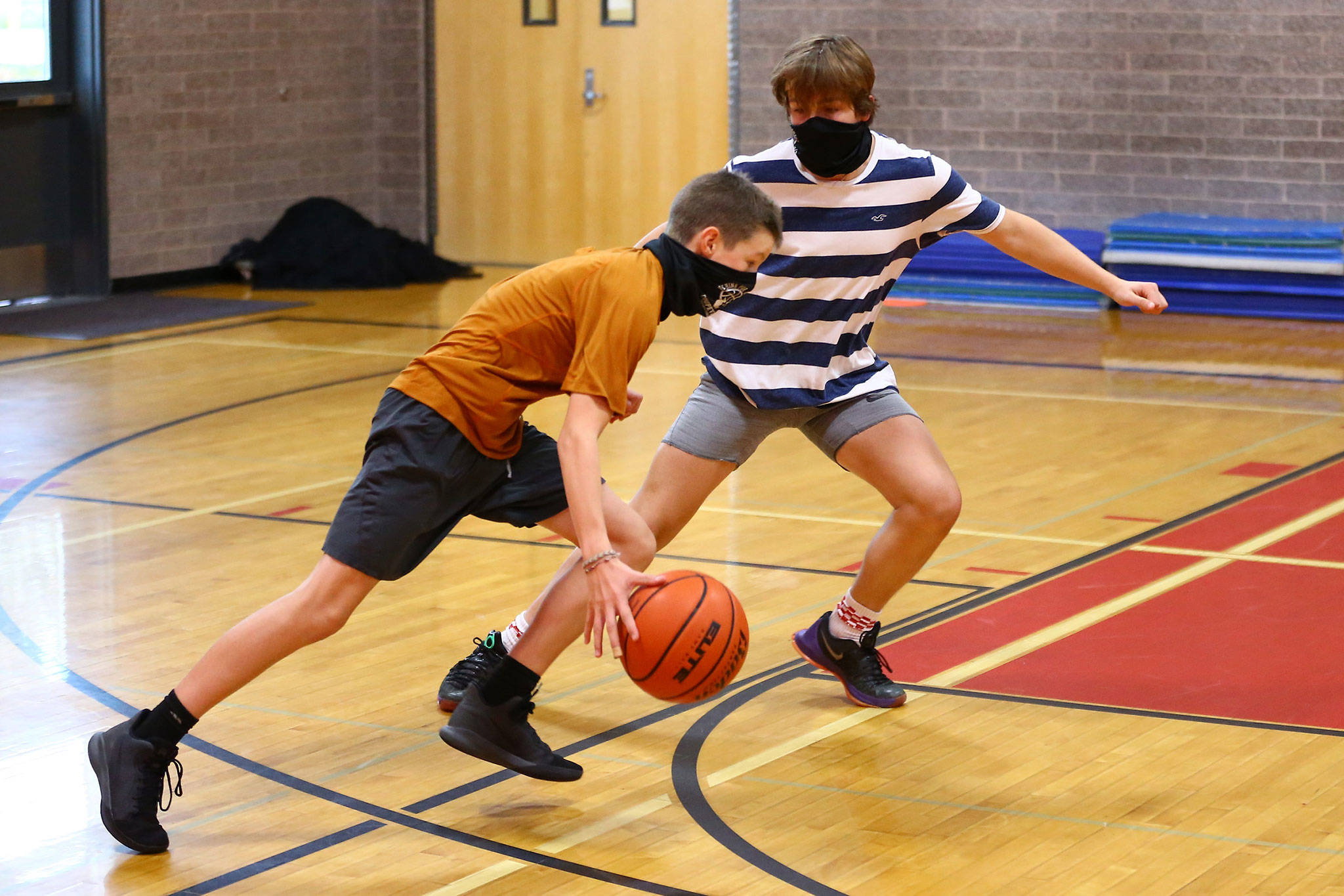 Coupeville’s Cole White dribbles against the defense of Logan Downes at a boys basketball workout this week. (Photo by John Fisken)