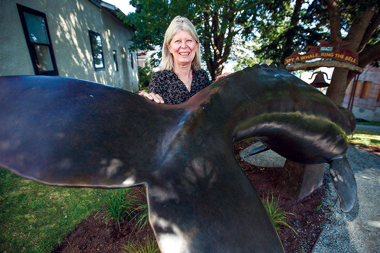 Georgia Gerber with her whale statue on display along First Street on Thursday, Aug. 13, 2020 in Langley, Wa. (Olivia Vanni / The Herald)