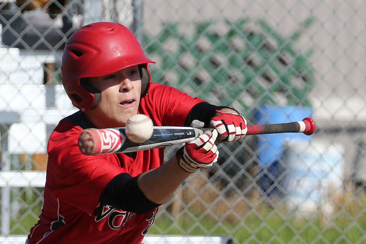 Coupeville’s CJ Smith puts down a bunt for the Wolves in 2016. (Photo by John Fisken)