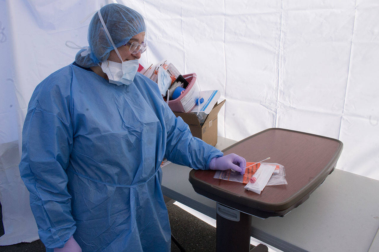 In a year dominated by COVID-19, nurse conducted tests at a WhidbeyHealth makeshift drive-thru tent in the back parking lot in March. File photo by Brandon Taylor/Whidbey News-Times