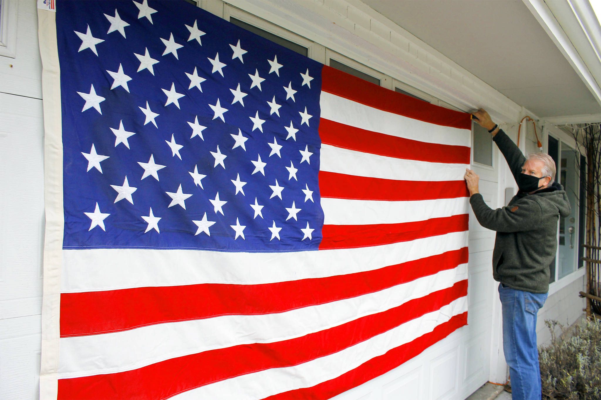 South Whidbey resident Doug Hansen displays a large American flag Wednesday that once flew over the White House during the Jimmy Carter Administration. Photo by Kira Erickson/Whidbey News-Times