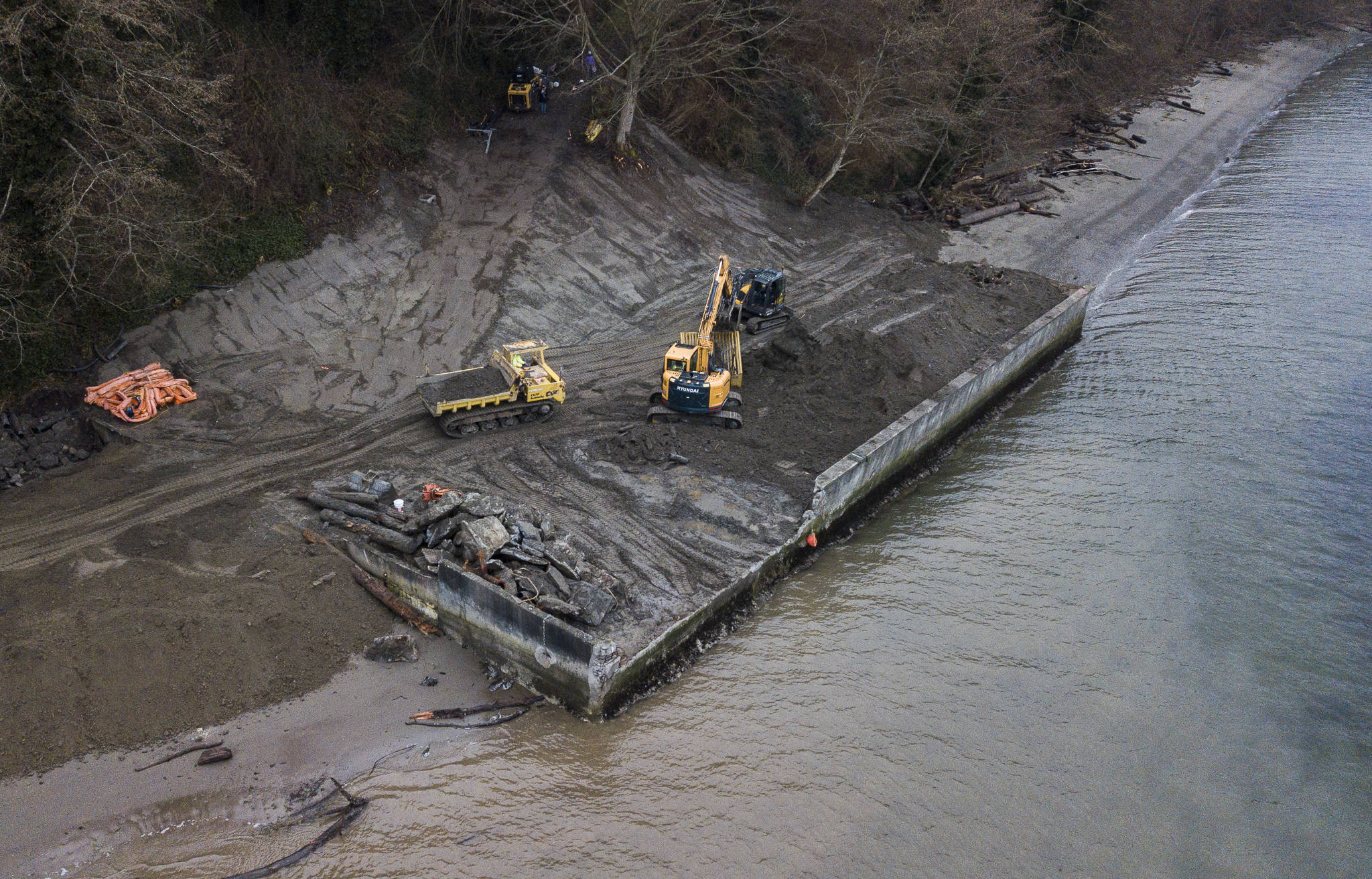 Dirt is moved during the deconstruction of a seawall north of Langley on Whidbey Island. (Olivia Vanni / The Herald)