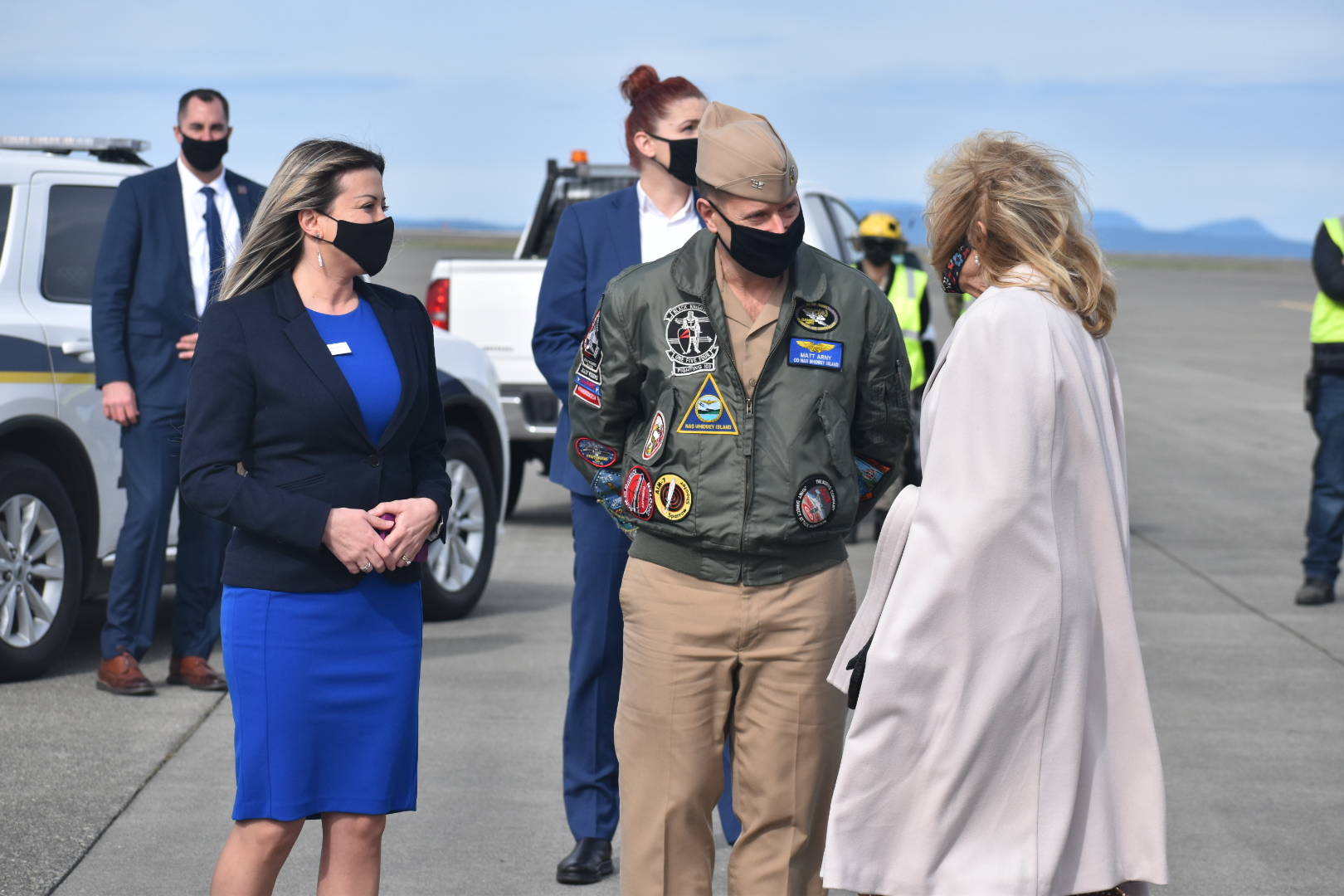 Upon her arrival at Naval Air Station Whidbey Island Tuesday, Dr. Jill Biden, at right, is greeted by base commander Capt. Matt Arny and his wife Samar. Photo by Emily Gilbert/Whidbey News-Times