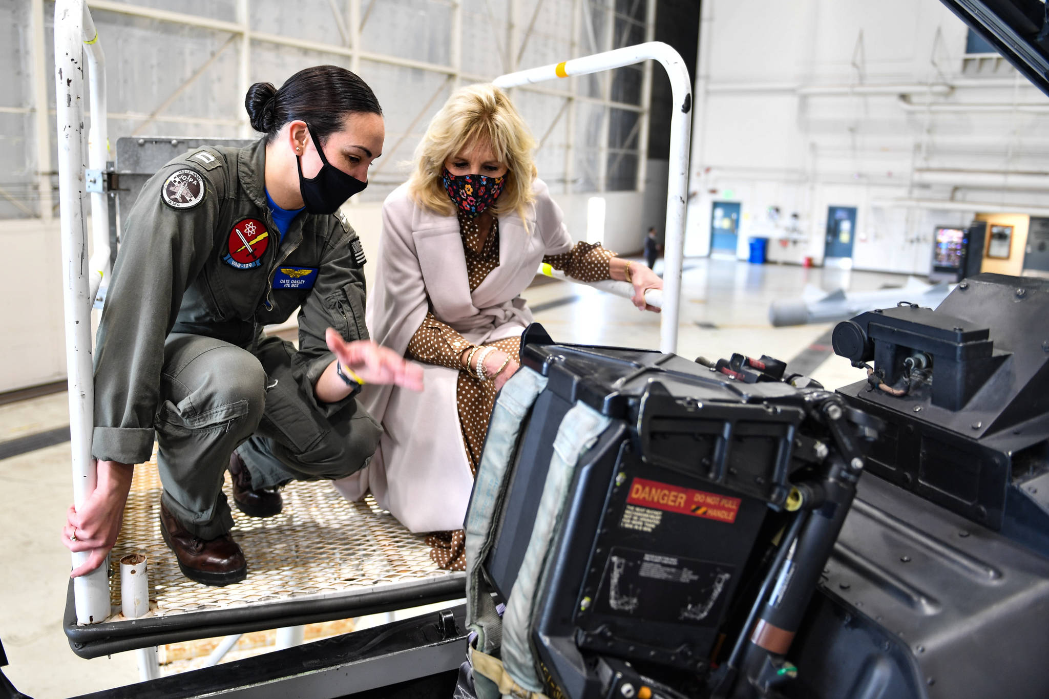 Photo by U.S. Navy Photo by Mass Communication Specialist 3rd Class Aranza Valdez
Lt. Cate Oakley shows an aircraft to First Lady Dr. Jill Biden at Naval Air Station Whidbey Island March 9, 2021. Dr. Biden visited the base to show support for military members and their families, and talk about the Joint Forces Initiative.