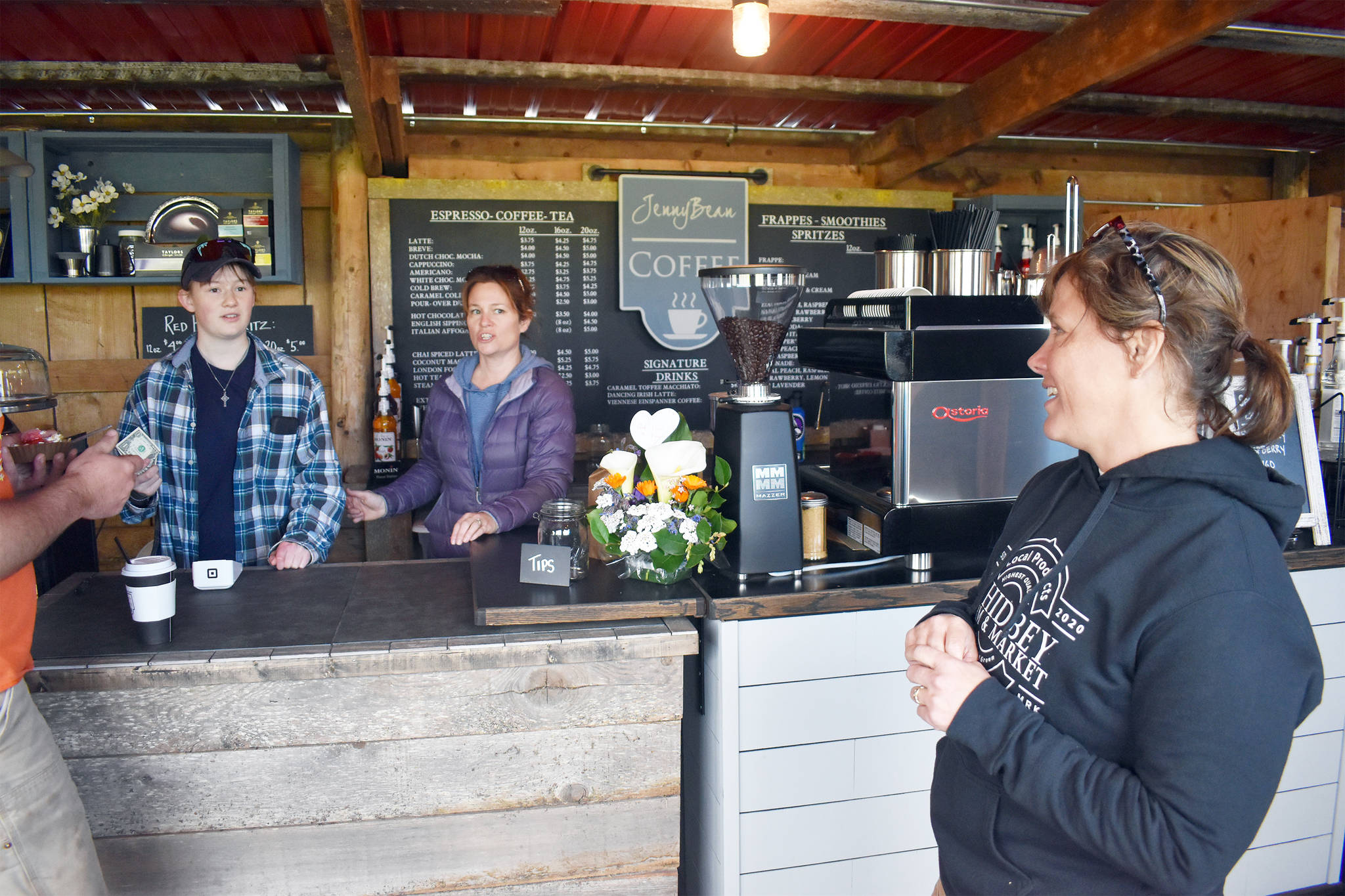 Jennifer Meffert and her daughter McKaela talk with Whidbey Farm and Market co-owner Wendi Hilborn while working at Meffert’s JennyBean Coffee’s espresso bar at the market. Photo by Emily Gilbert/Whidbey News-Times