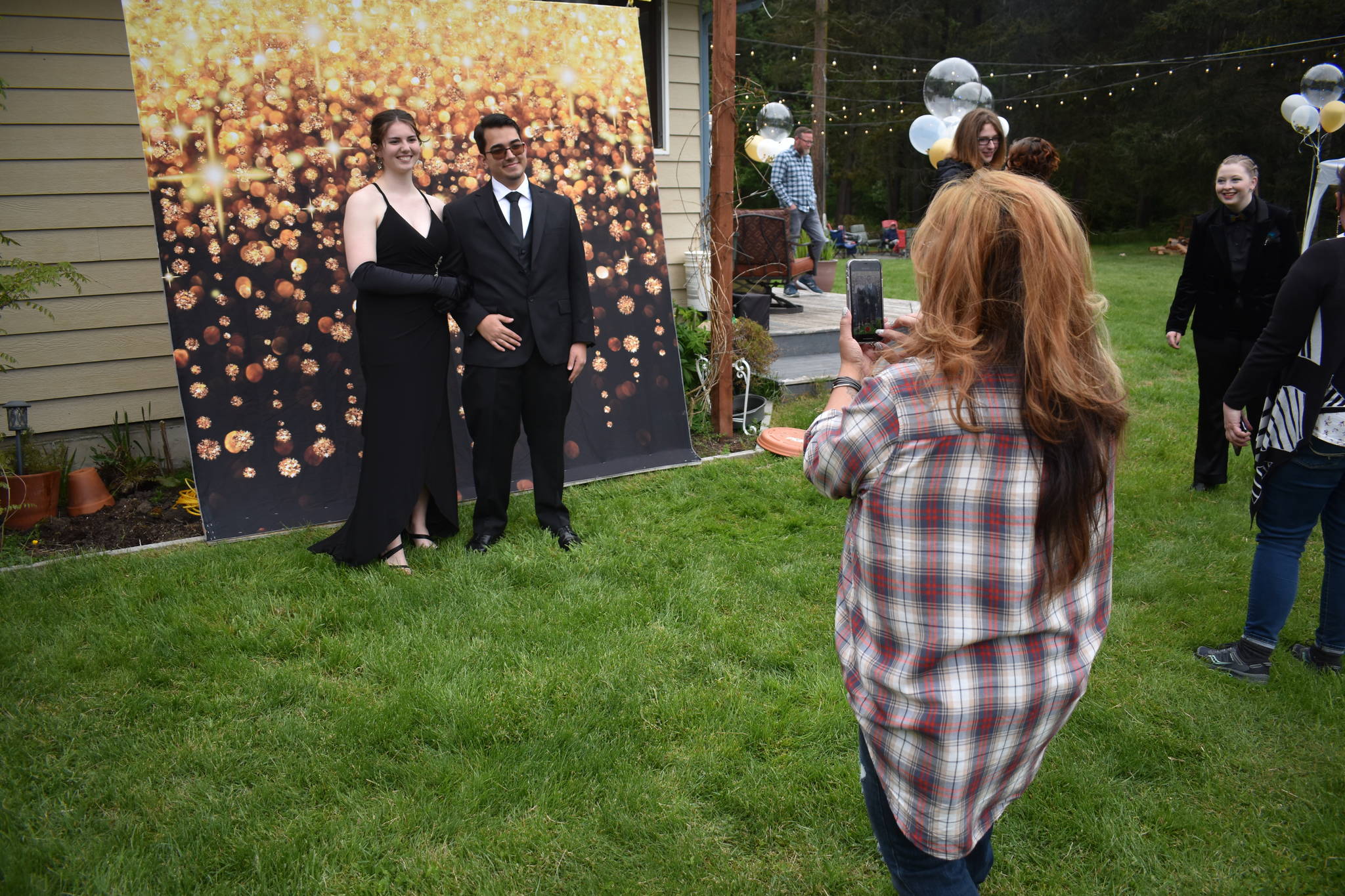 Synnove Svendsen and her boyfriend Landon Pohlman pose for a picture at a prom hosted in her family’s backyard last Saturday. (Photos by Emily Gilbert/Whidbey News-Times)