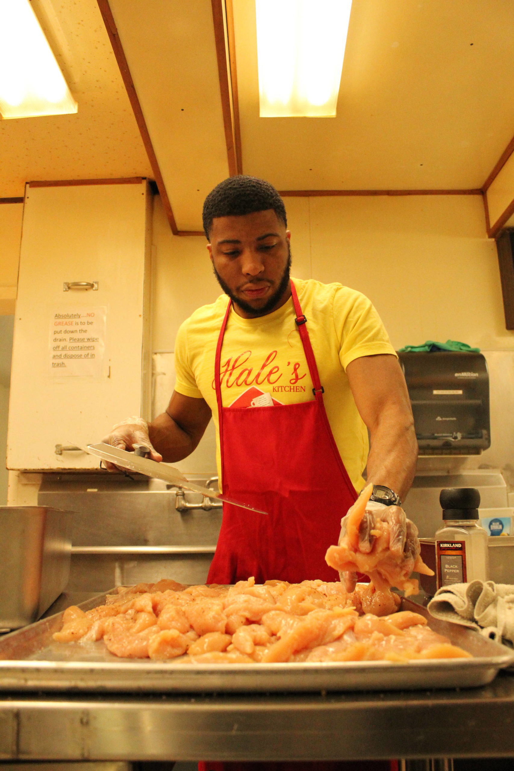 Jamel Hale prepares chicken at his restaurant, Hales Kitchen, May 20. (Photo by Karina Andrew/Whidbey News-Times)