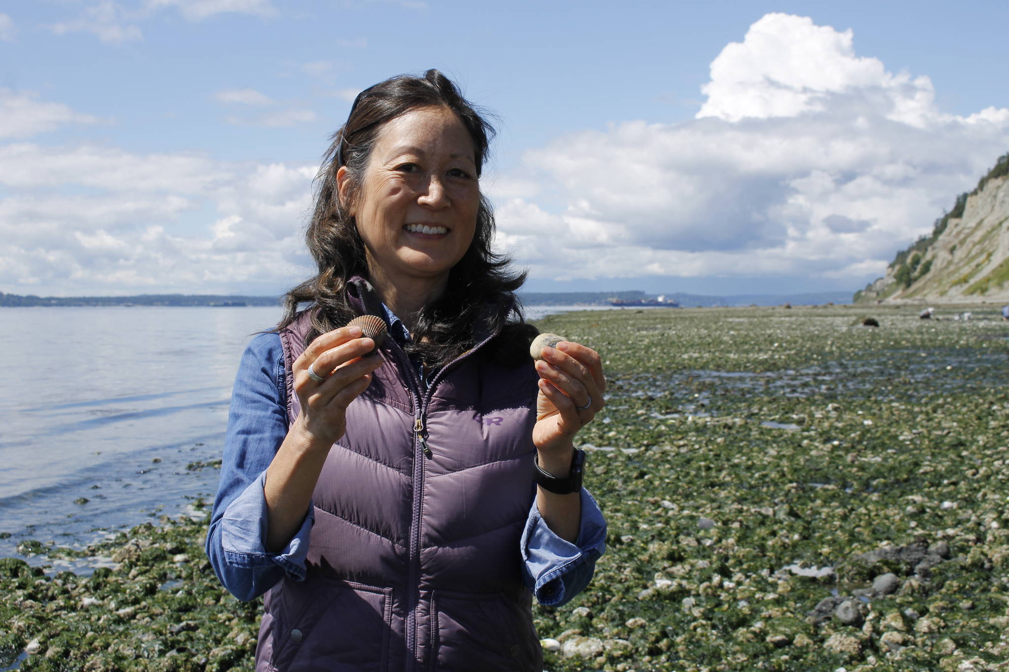 Photo by Kira Erickson
Instructor Michele Sakaguchi holds up two clams found while digging. Clams must be a certain size in order to be harvested.