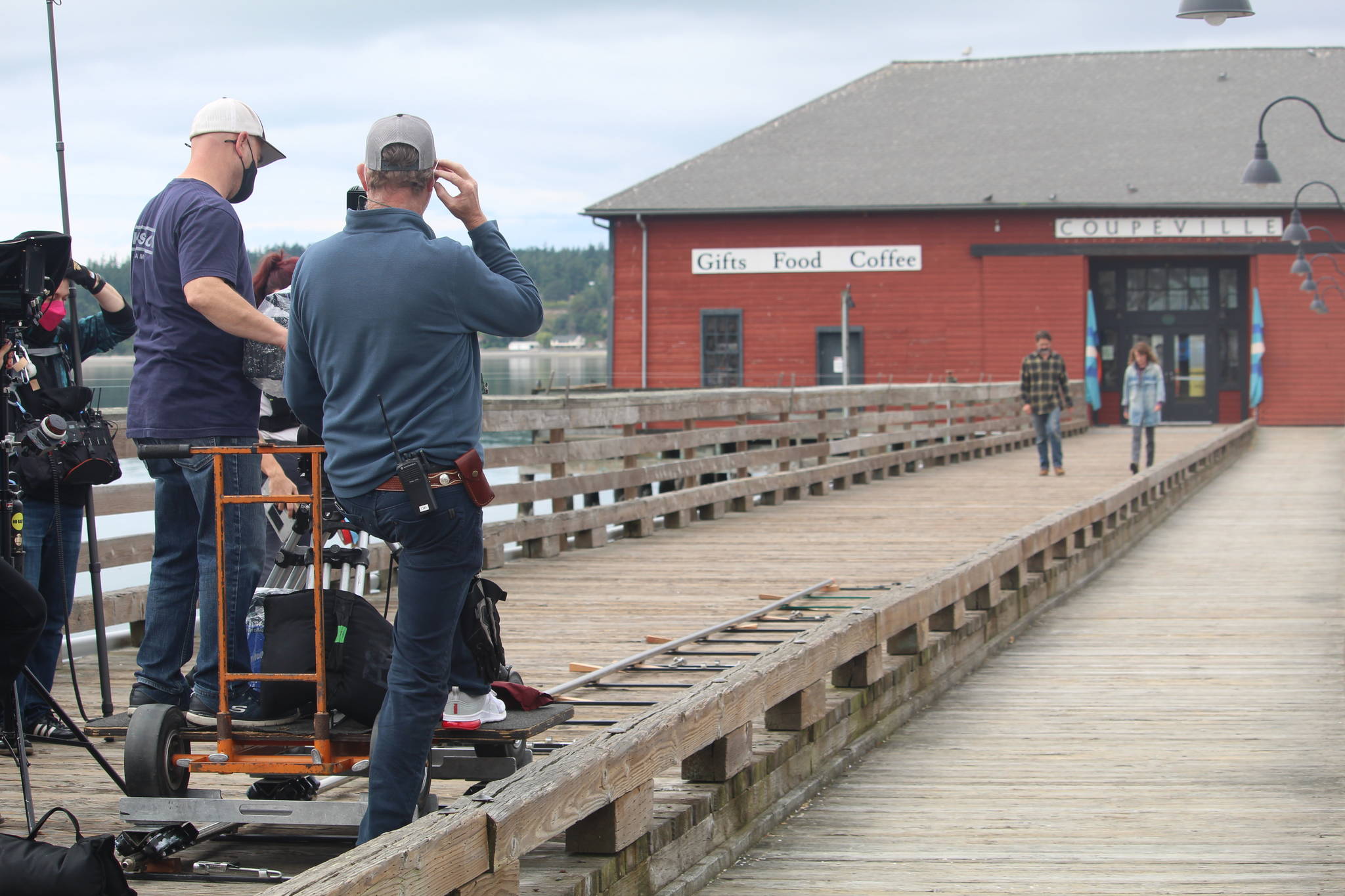 Chris Stack and Samantha Soule film a scene of their movie, “Midday Black, Midnight Blue,” on the Coupeville wharf June 14. (Photo by Karina Andrew/Whidbey News-Times)