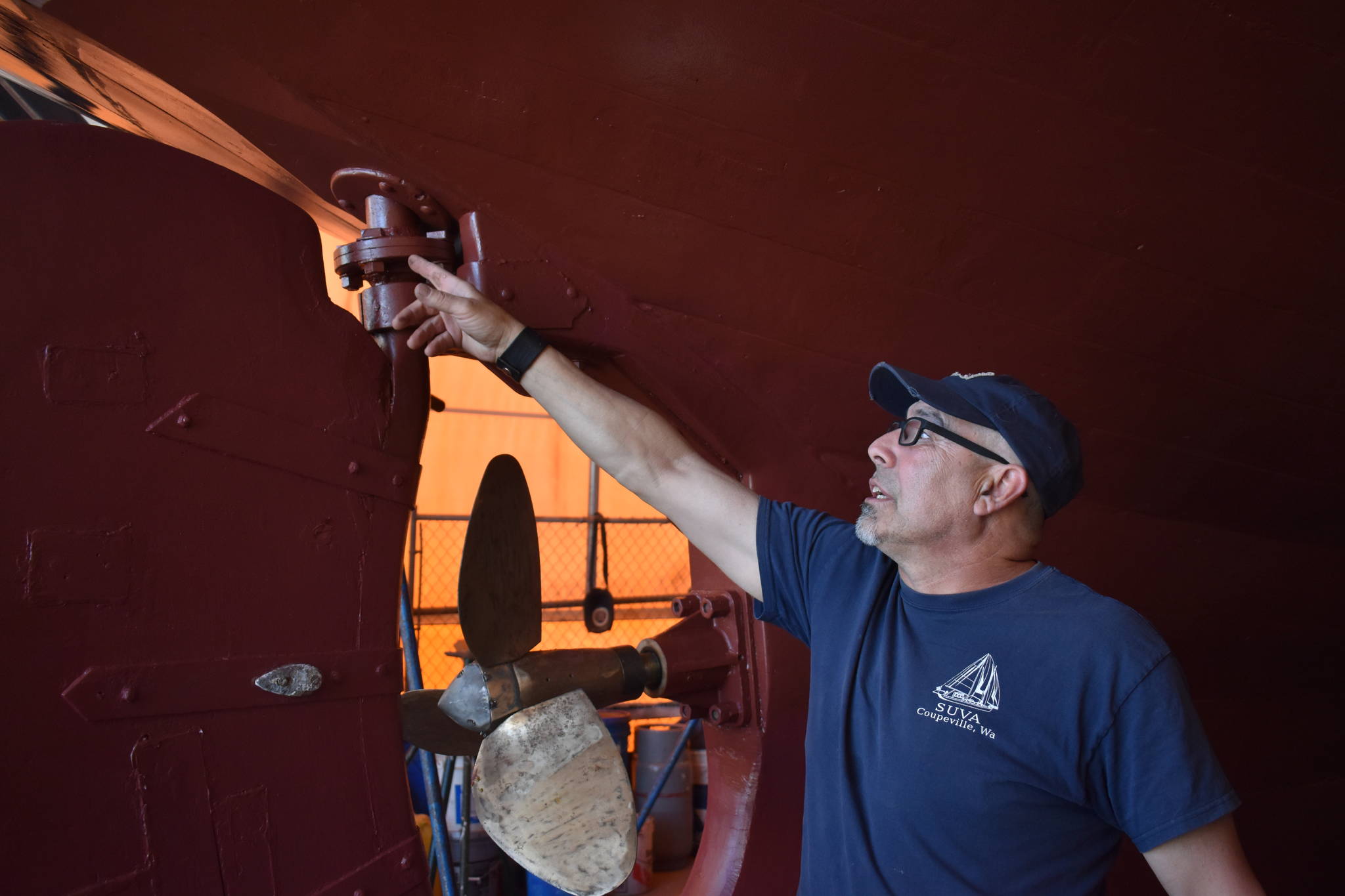 Photo by Emily Gilbert/Whidbey News-Times
Mark Saia points to a repair on the Gatsby-era schooner, the <em>Suva</em>. It recently went through major repairs and is ready for a summer of sailing.