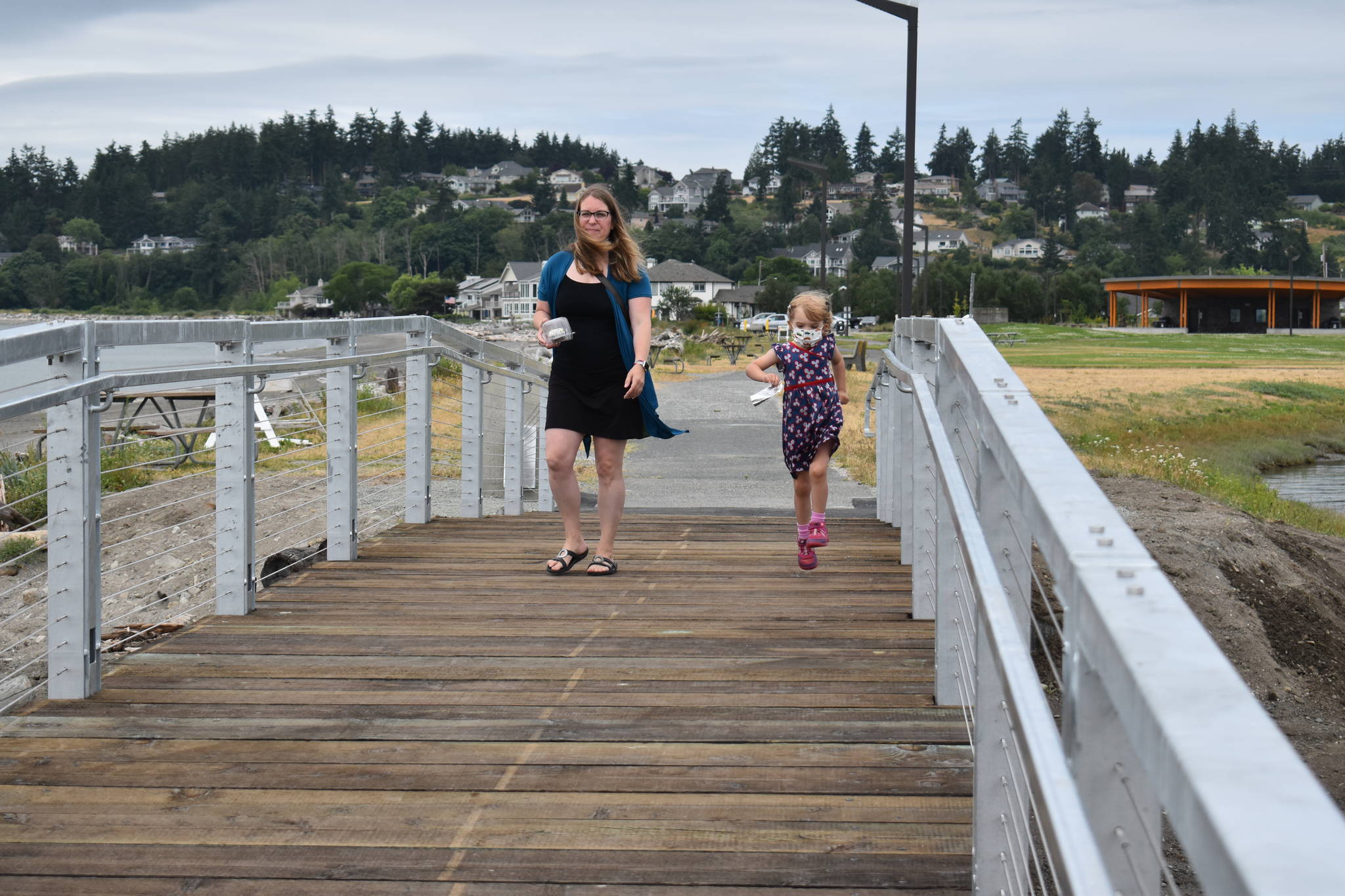Photo by Emily Gilbert/Whidbey News-Times Katie Toft and her four-year-old daughter Bailey walk across the newly renovated Rotary Memorial Bridge. Katie Toft’s father, Dick Toft, is one of the Rotarians memorialized on a plaque next to the bridge.
