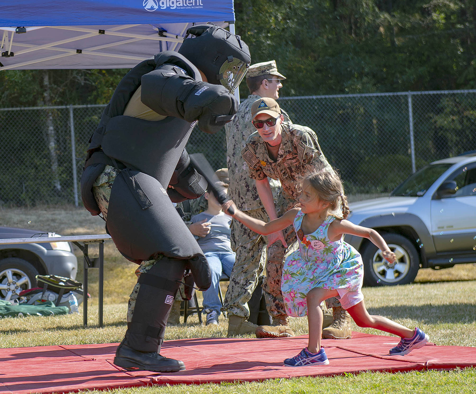 File photo
Master-at-Arms 1st Class Nick Fortune gives instruction during a take down demonstration to visitors in attendance of National Night Out on Fort Nugent Park in 2019. National Night Out is an annual community-building campaign that promotes police-community partnerships and neighborhood camaraderie and is coming back this year on Aug. 3. (U.S. Navy photo by Mass Communication Specialist 2nd Class Marc Cuenca/Released)