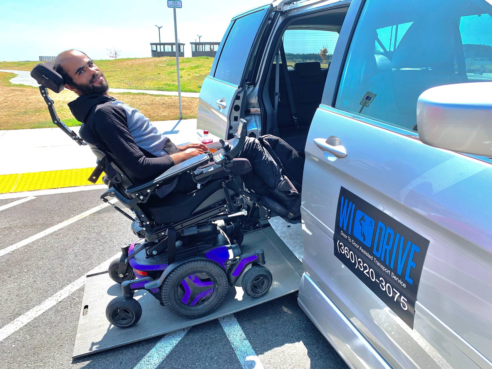 Stuart Peeples demonstrates how to enter Heather Mayhugh’s wheelchair van. In recent months, while navigating the new Mukilteo ferry terminal, Mayhugh has struggled to unload her clients who need access to the restroom. (Photo by Heather Mayhugh)