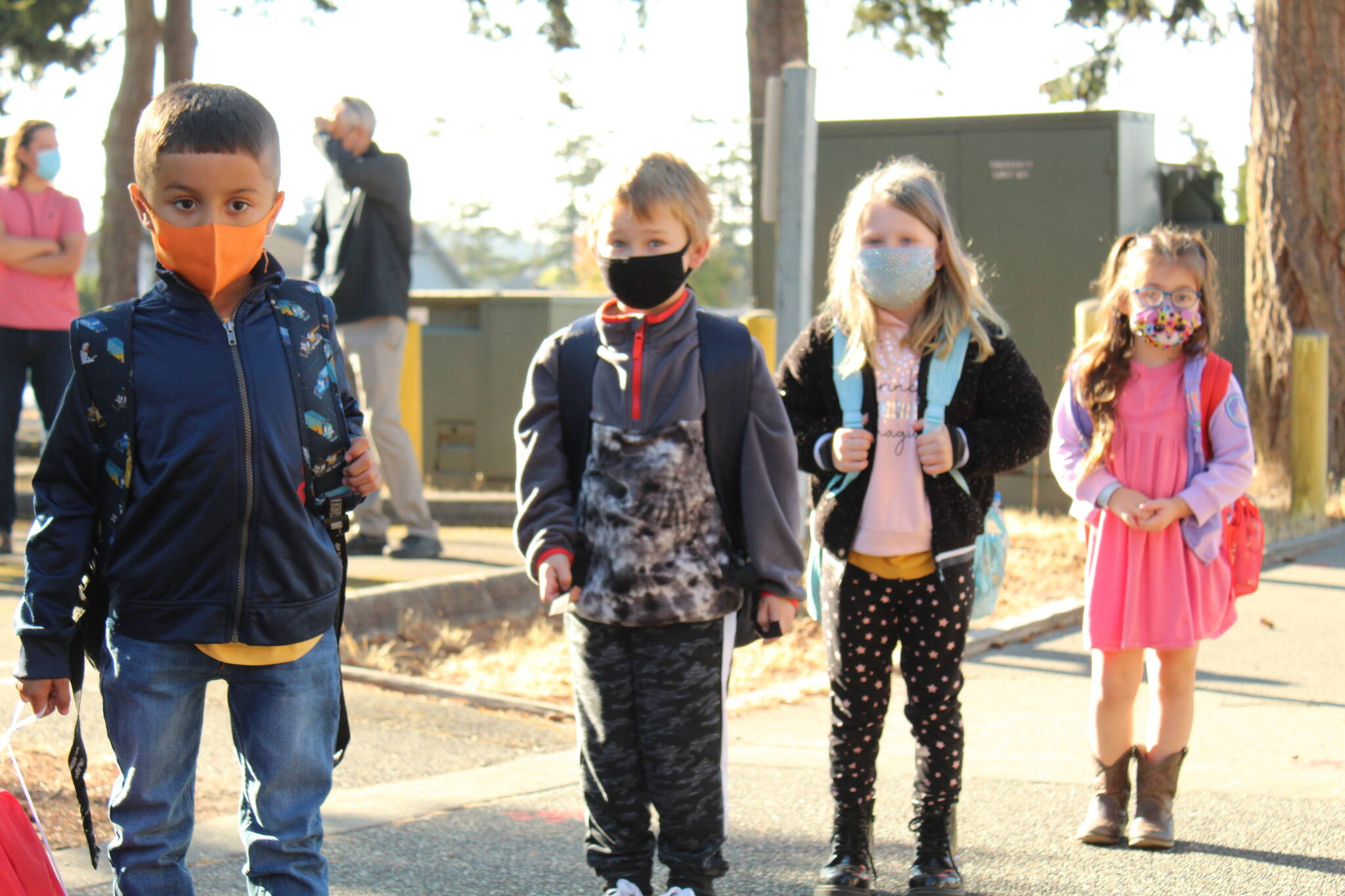 From left, Leo Hernandez-Gomez, Rex Burley, Adelaide Burley and Valerie Trevino wait in line to enter the school and find their new classrooms. (Photo by Karina Andrew/Whidbey News-Times)