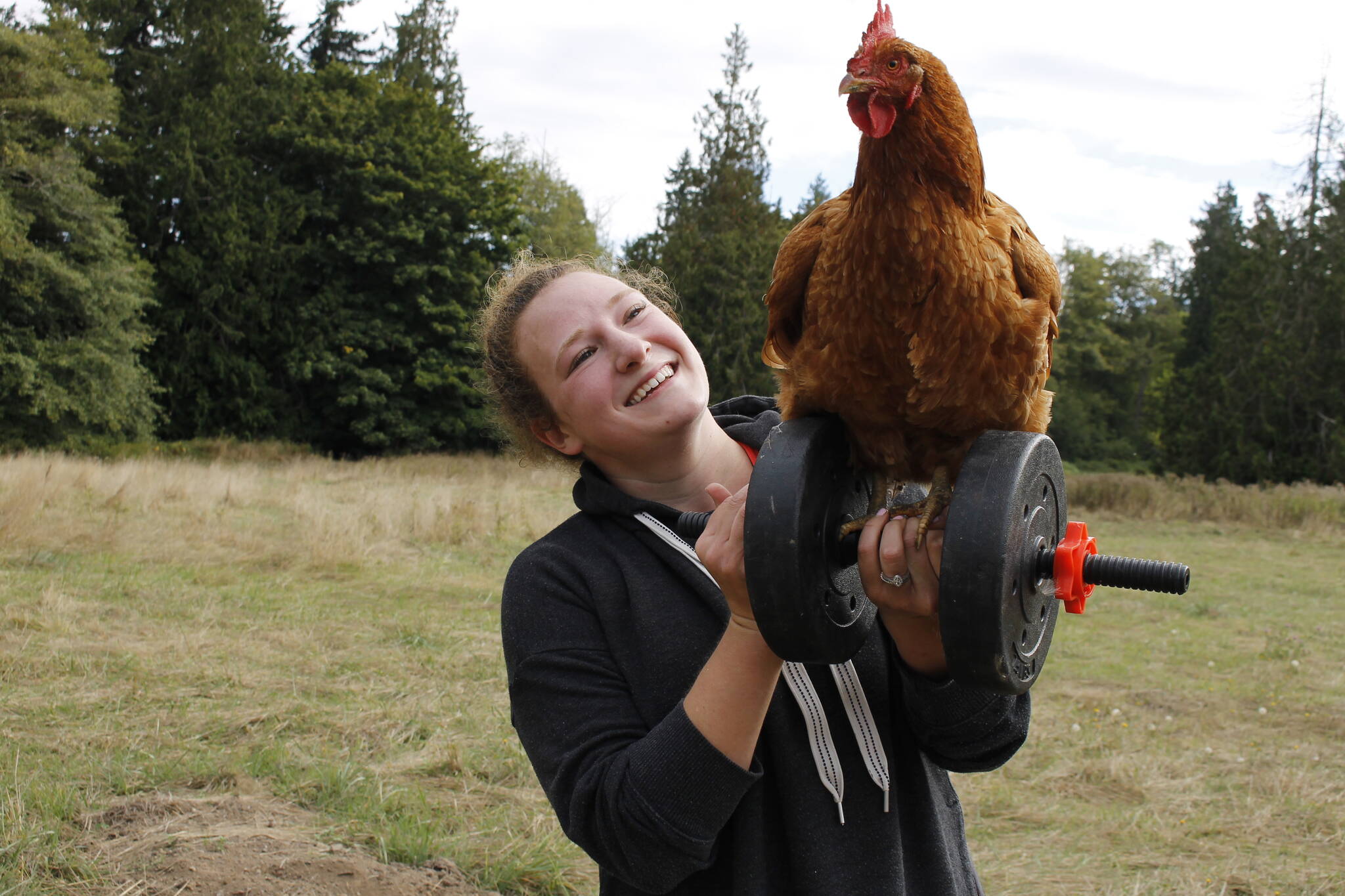 Photo by Kira Erickson/South Whidbey Record
Sarah Santosa lifts a chicken and a weight.