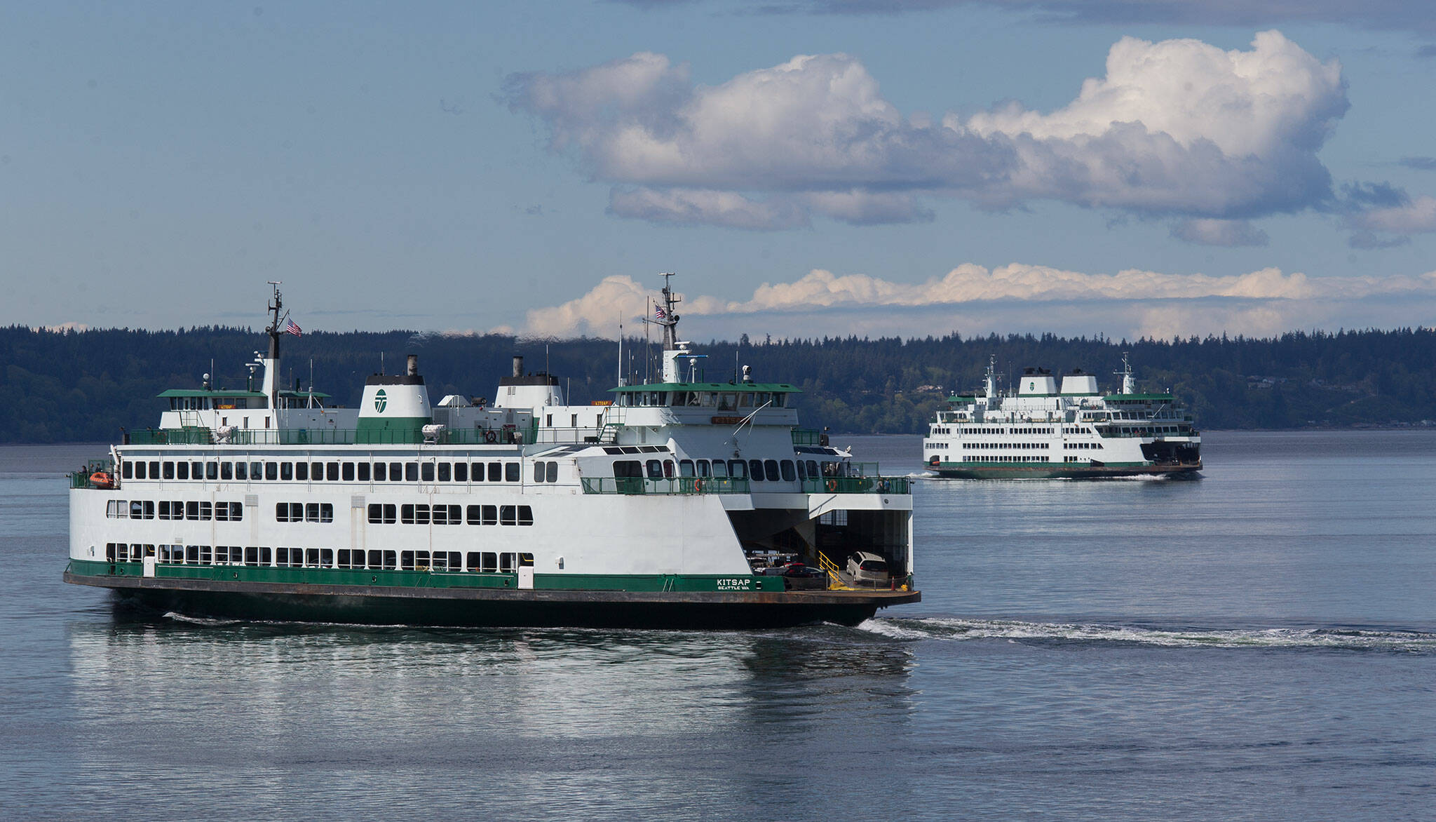 Ferries pass during a crossing from the Mukilteo Ferry Terminal and the Clinton Terminal on Monday, April 26, 2021 in Mukilteo, Washington.  (Andy Bronson / The Herald)