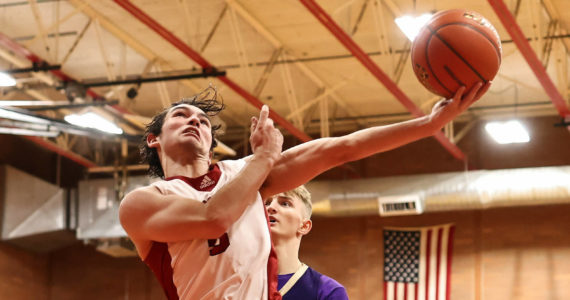 Photo by John Fisken
Coupeville High School senior Hawthorne Wolfe jumps for the hoop during a game against island rival Oak Harbor Wednesday. Coupeville came back from a 10-point deficit to win the first game of the year 70-64.
