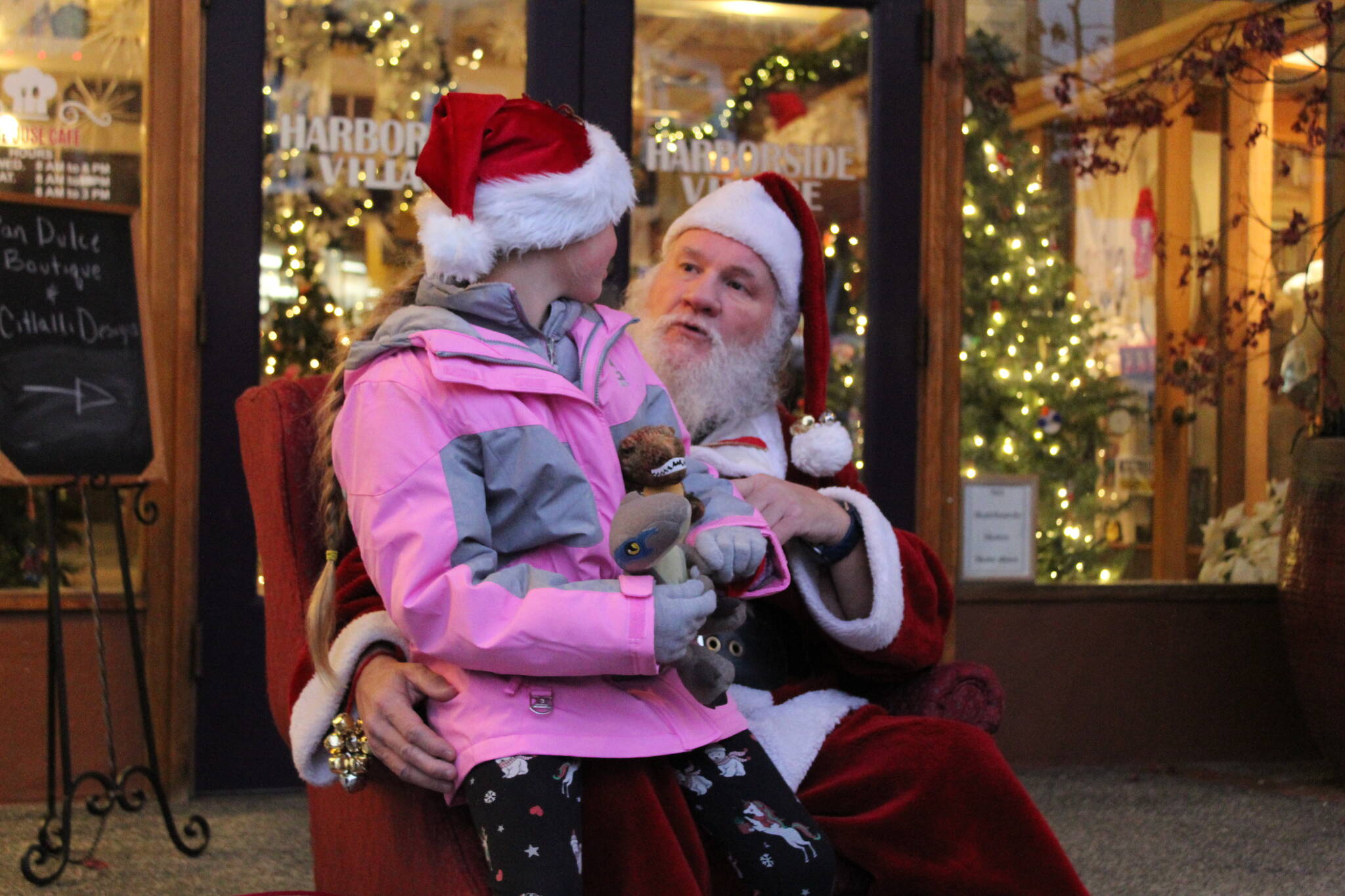 Photo by Karina Andrew/Whidbey News-Times
Lauren Vasileff, age 9, tells Santa what she wants for Christmas this year.