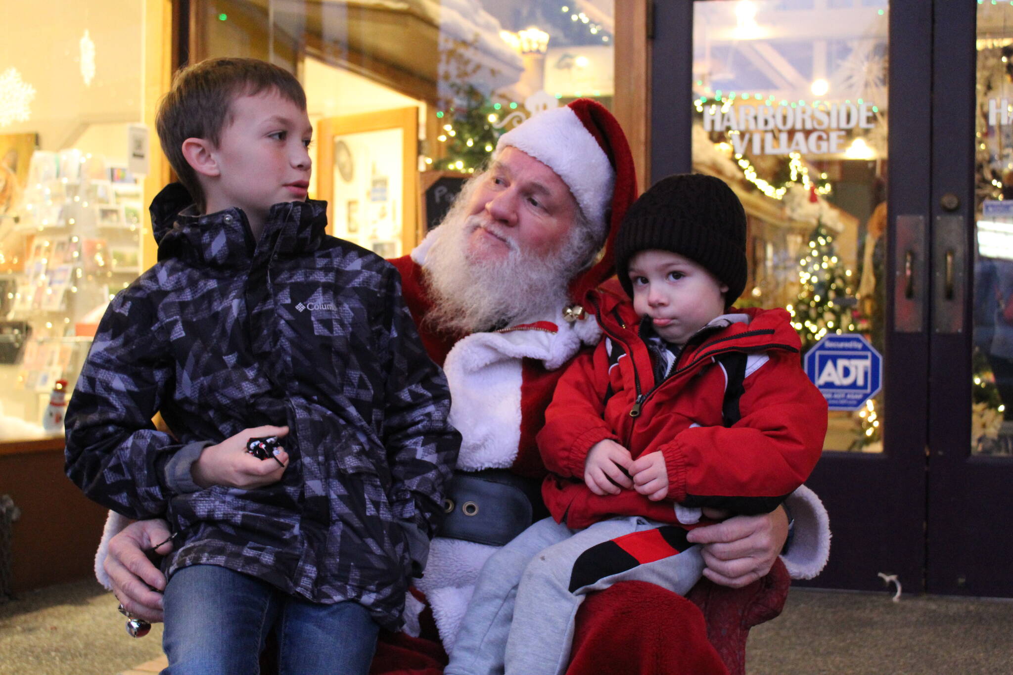 Photo by Karina Andrew/Whidbey News-Times
August Stohmire, 2, and his young uncle Ryan Brown, 9, meet Santa Claus Dec. 4. on Pioneer Way.
