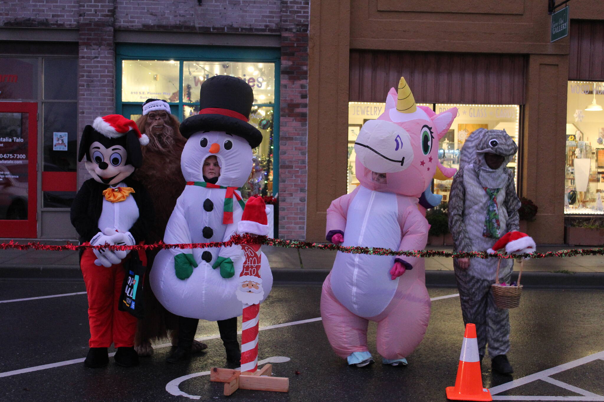 Photo by Karina Andrew/Whidbey News-Times
Santa brought an unusual gaggle of helpers with him from the North Pole to the Oak Harbor tree lighting, including Mickey Mouse, Sasquatch, a walking snowman, a pink unicorn and a squirrel.