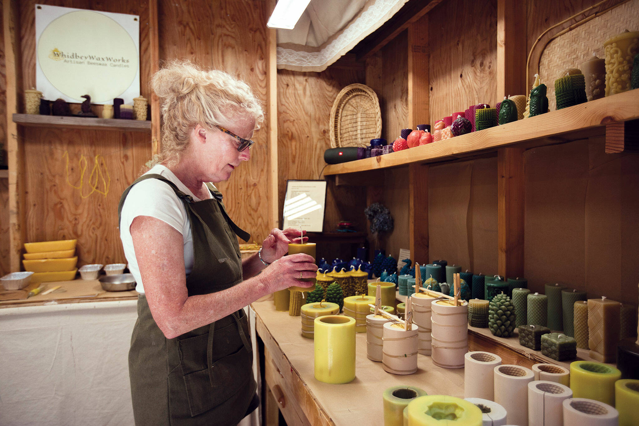 Priscilla Lowry makes candles at her workshop on south Whidbey Island. (Olivia Vanni / The Herald)