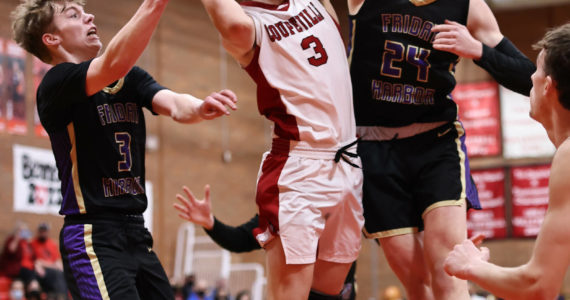 Photo by John Fisken
Coupeville sophomore Logan Downes takes a shot during the Wolves’ senior night game against Friday Harbor Jan. 19. Despite trailing during a low-scoring first half, the Coupeville players managed a 49-34 victory, maintaining their undefeated season.