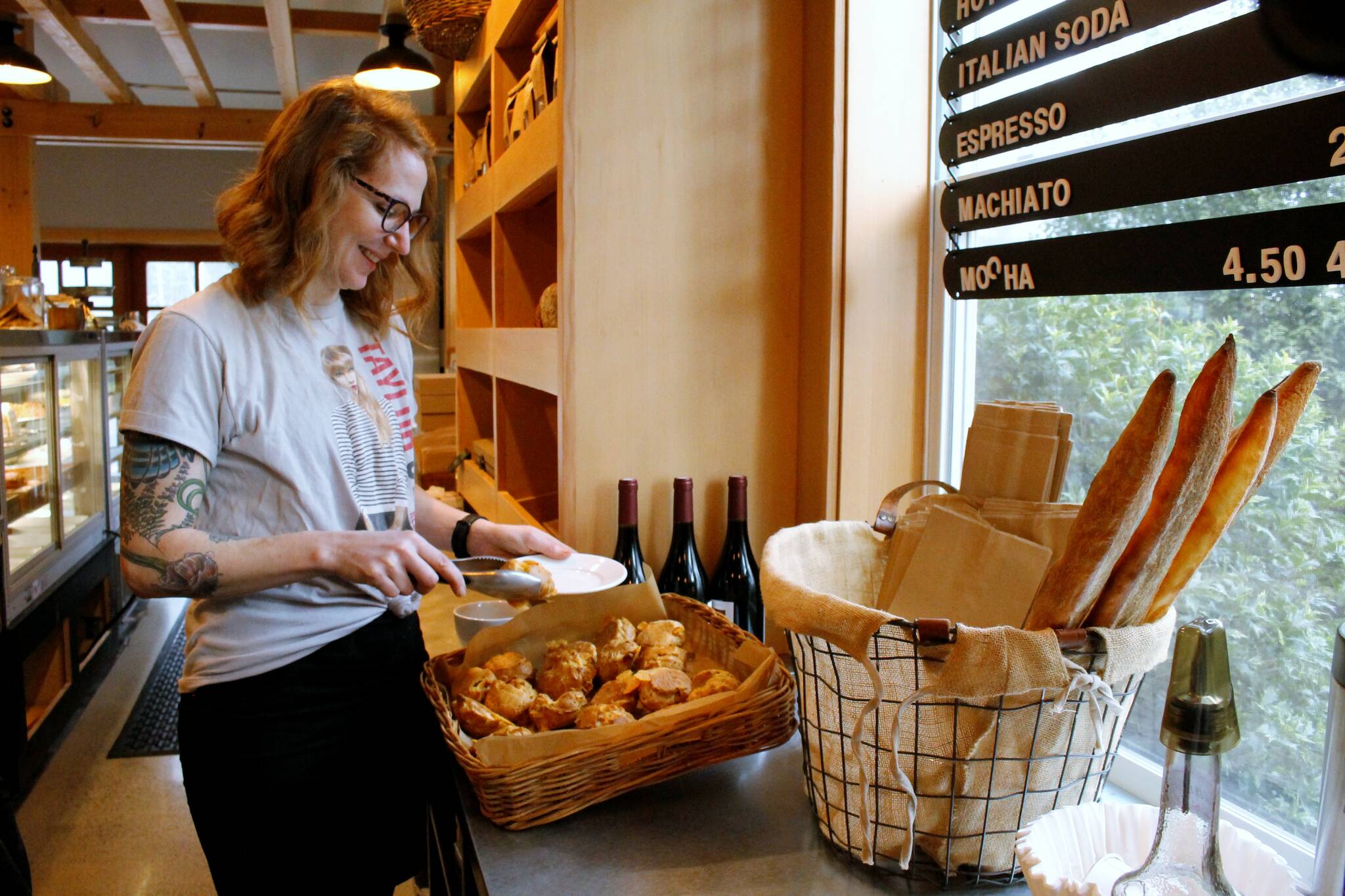 Photo by Kira Erickson/South Whidbey Record
Hannah McCabe, the manager of Seabiscuit Bakery, grabs a gougère to serve.
