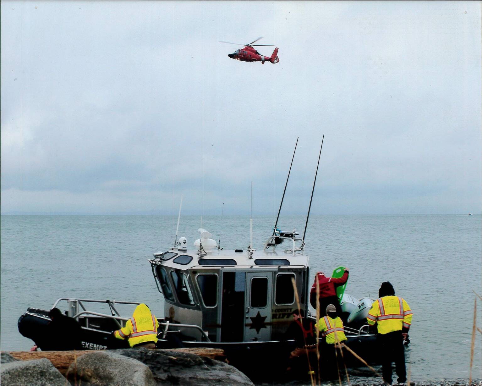 Photo provided
An Island County Sheriffs Office boat and a Coast Guard helicopter set out to retrieve a body near Whidbey Island.