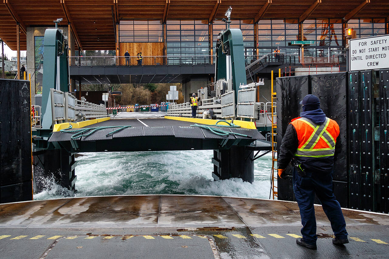 Photo by David Welton
A ferry worker gazes back at the Mukilteo ferry terminal as the vessel departs the dock. Recently, service on the Mukilteo-Clinton route has been cut down to one boat more often than not.
