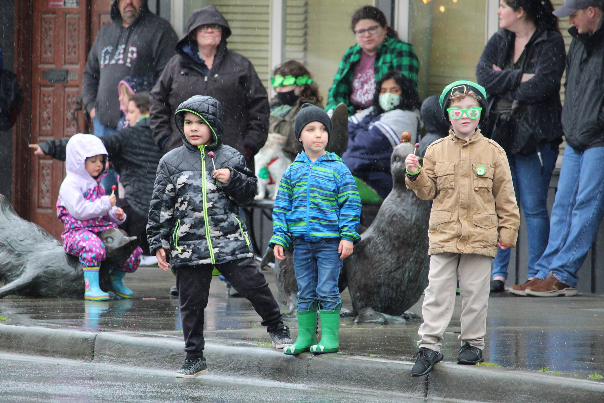 Oak Harbor children brave Thursday’s rain to watch the St. Patrick’s Day parade in the hopes of getting some candy.