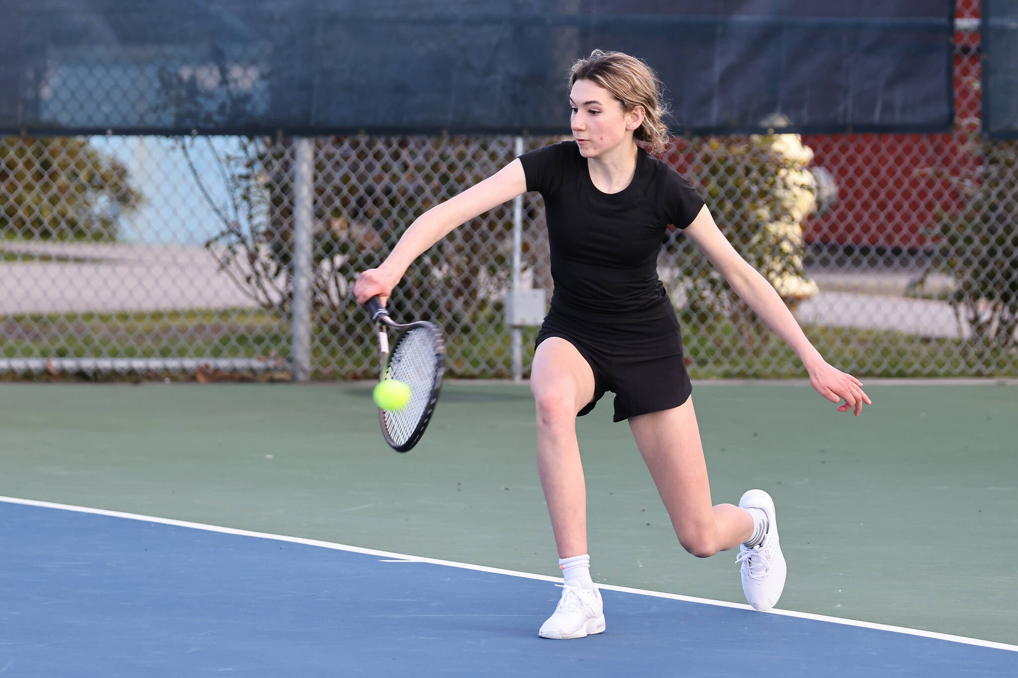 Photo by John Fisken
South Whidbey junior Abby Amundson, No. 1 singles in varsity, returns the ball during a match against Oak Harbor March 16.