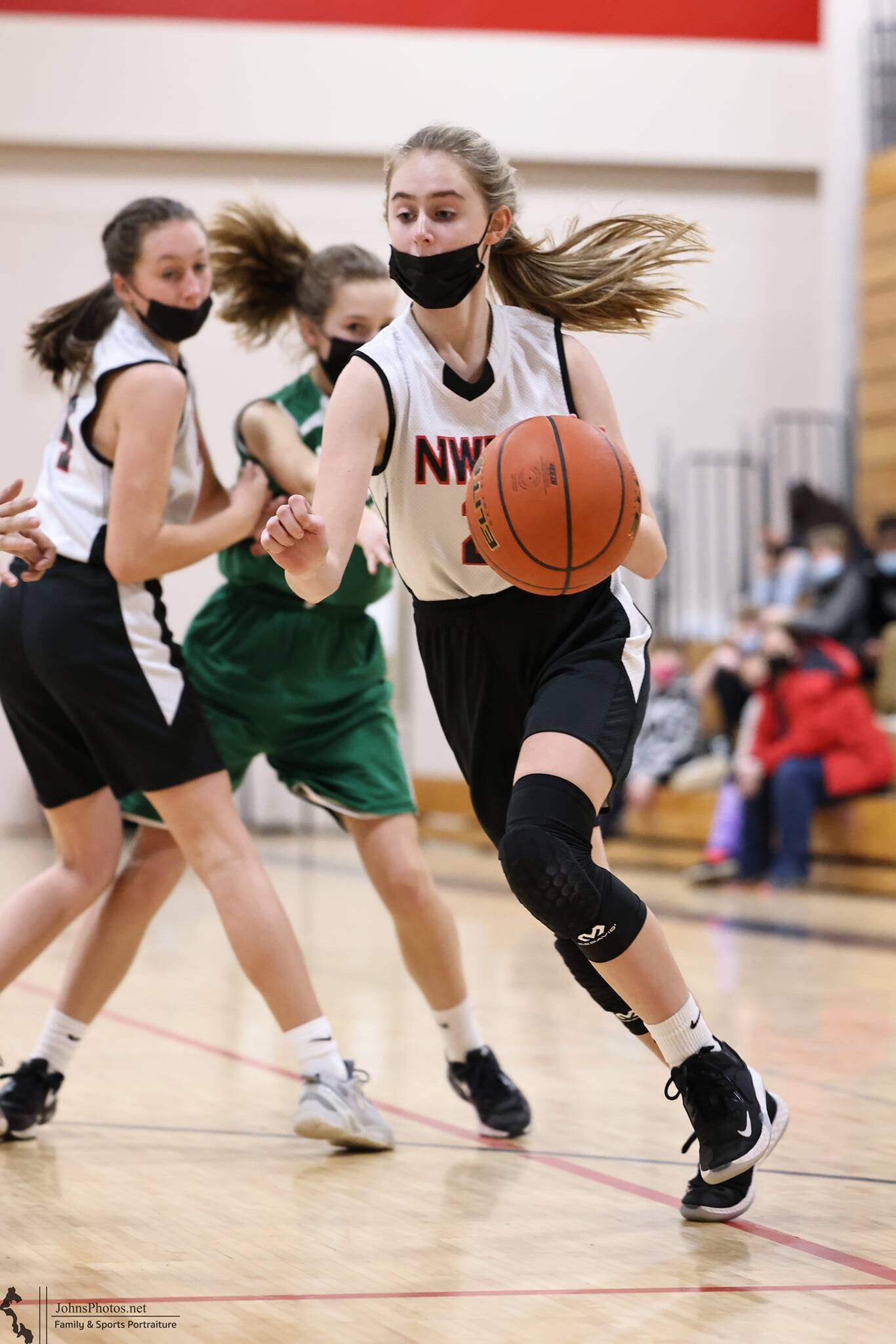 Photo by John Fisken
Scarlett Nations plays with her eighth grade team in a basketball game against LaVenture Middle School, one of eight games the team won handily for an undefeated season.