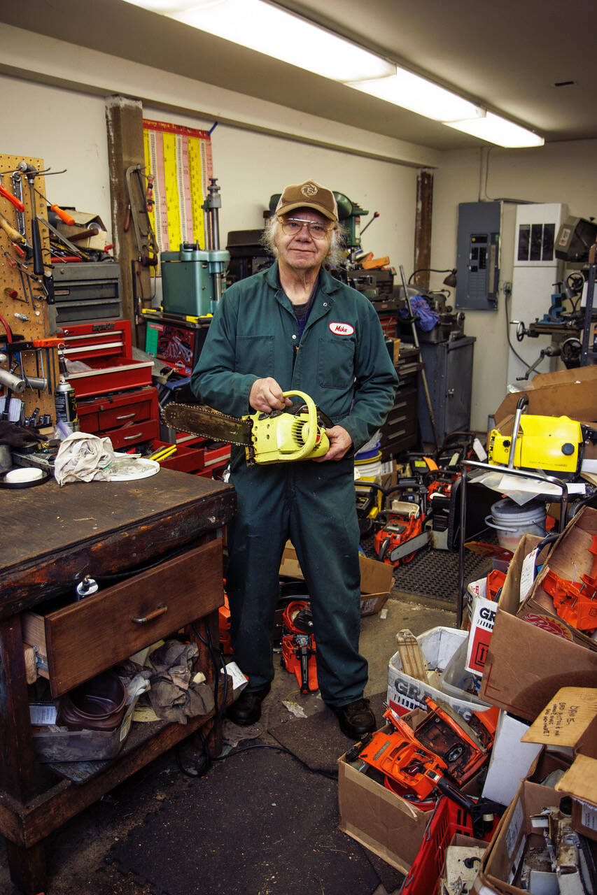 Photo by David Welton
With just about every tool and part imaginable in his shed, Gallion holds one of the chainsaws he is repairing.