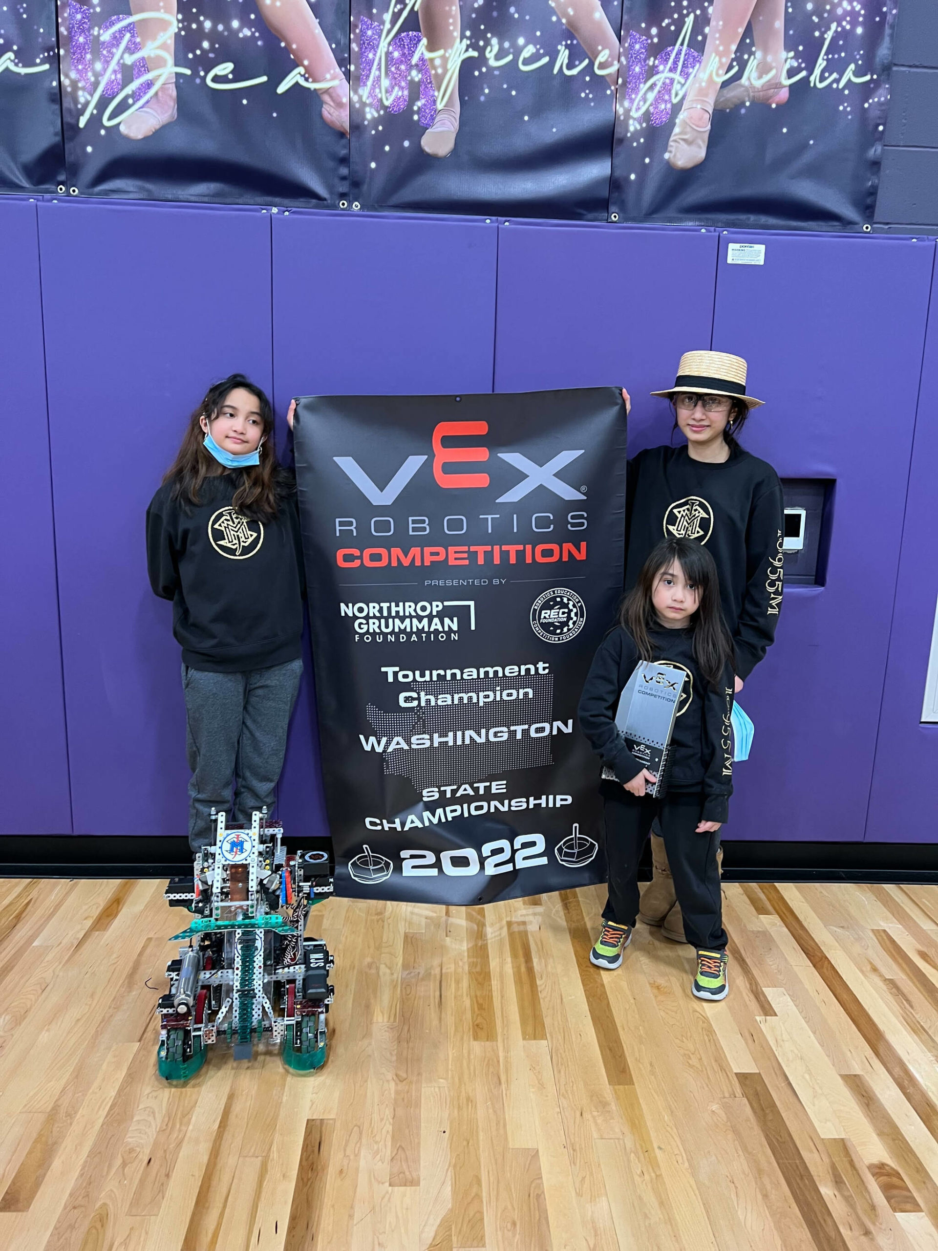 Photo provided
Misaella Jomiya Serrantes, left, Mikayla Jomika Serrantes, back right, and Mikoilo Jomiko Serrantes compete at the VEX Robotics State Championship March 13.