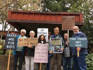 Photo provided
Members of the Not in Our Parks Coalition hold signs protesting Navy training in state parks.