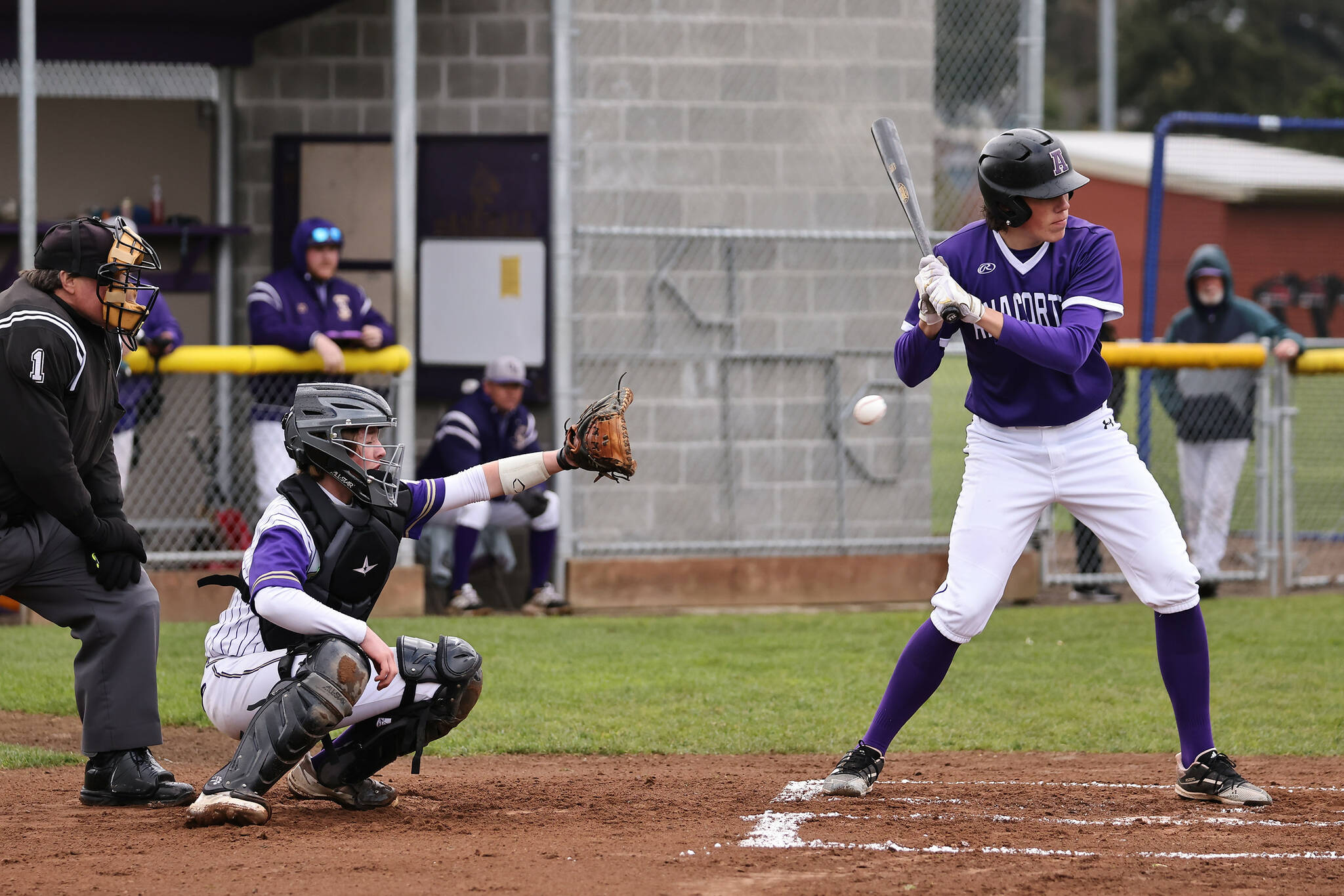 Photo by John Fisken
Parker Anderson catches a pitch missed by an Anacortes player during a baseball game April 4. Oak Harbor won after a close game.