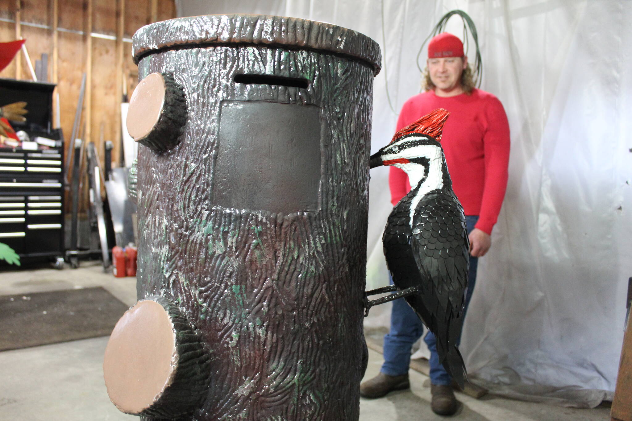 Casey Strelecki designed a donation box in the form of a tree stump adorned by a woodpecker. (Photo by Karina Andrew/Whidbey News-Times)