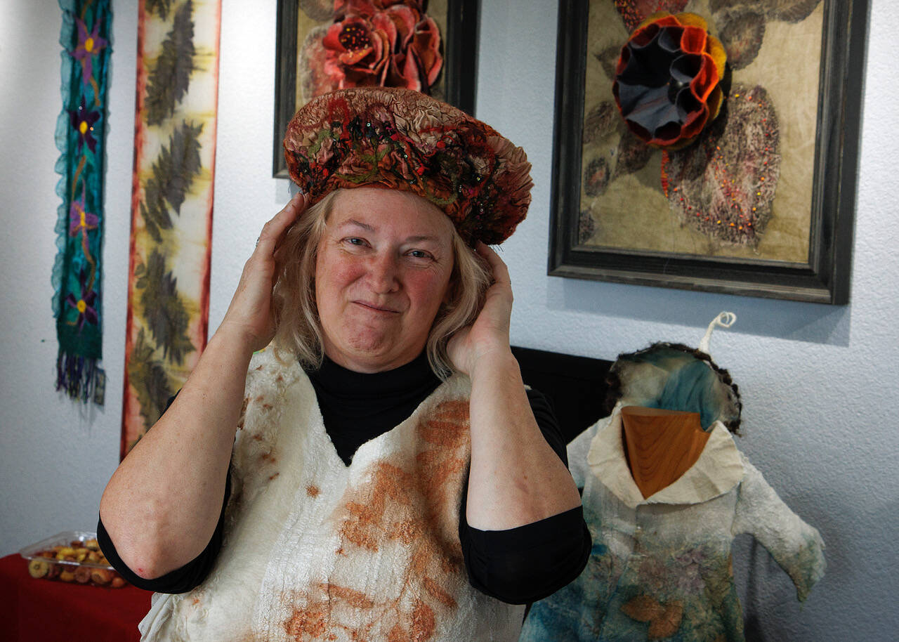 Fiber artist Janet King models a hat and a dress she made from felting. King is one of the participating artists on the Whidbey Art Trail this year. (Photo by David Welton)
