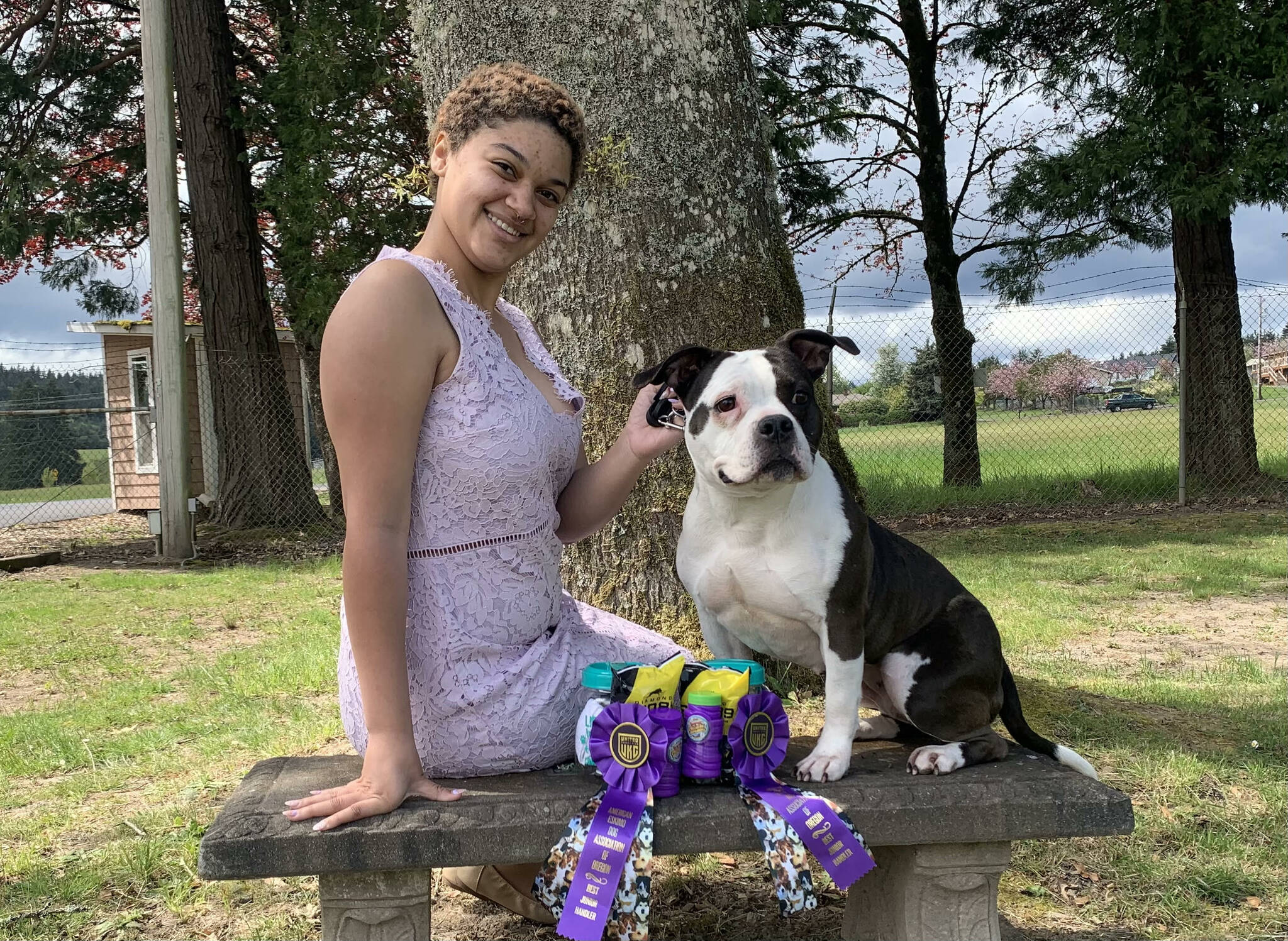 Maryah Love sits with a dog she handles and ribbons she won. (Photo by Mary Edwards)