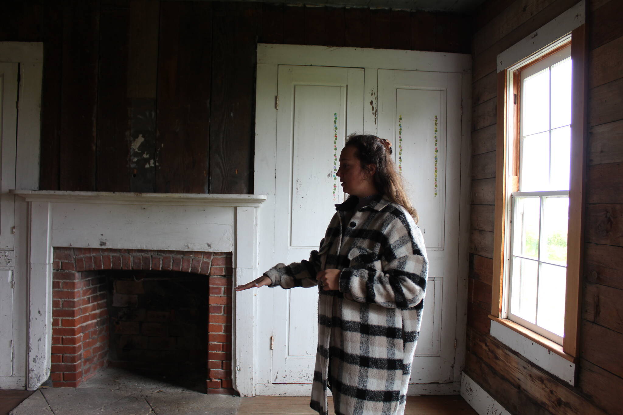 Reserve education and outreach coordinator Jordan Belcher shows the former dining room of the Jacob and Sarah Ebey House. (Photo by Karina Andrew/Whidbey News-Times)