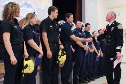 Captain Chris Geiger of North Whidbey Fire & Rescue congratulates firefighter Bradley Stevens from Central Whidbey Island Fire & Rescue after administering the Oath of Office at the graduation ceremony for the 2022 Whidbey Island Fire Academy. (Photo provided)