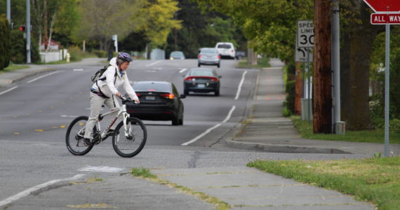 A woman bikes through an intersection in Oak Harbor. (Photo by Karina Andrew/Whidbey News-Times)